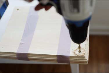 drilling a hole through two wood plaques