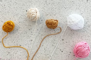 Five mini balls of yarn in various colors