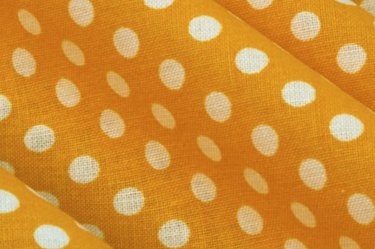White polka dots on yellow fabric