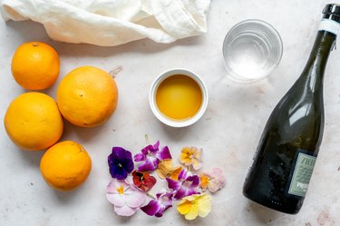 ingredients for the citrus spritz cocktail and edible flowers