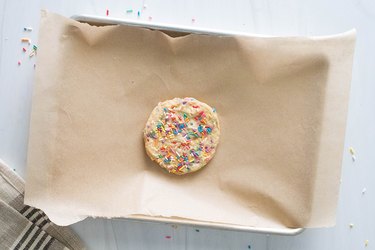 Single-serving birthday cake cookie on baking sheet