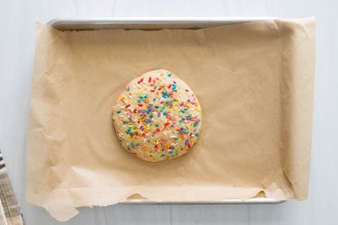 Single-serving birthday cake cookie on baking sheet