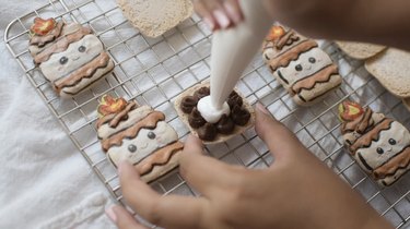 Piping marshmallow fluff in middle of chocolate ganache ring