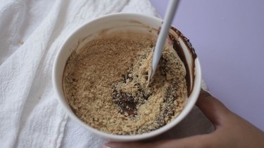 Crushed graham crackers in bowl of chocolate ganache