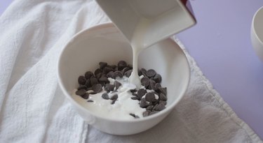 Pouring heavy cream into bowl with chocolate chips