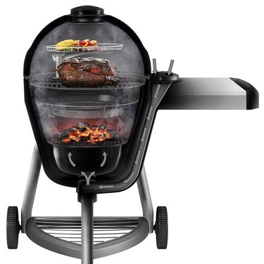 Char-Broil Kamander charcoal cooker, shown in cutaway view against a white ground