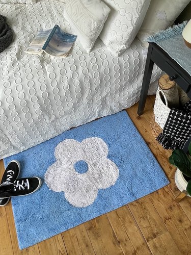 Duct tape rug next to bed