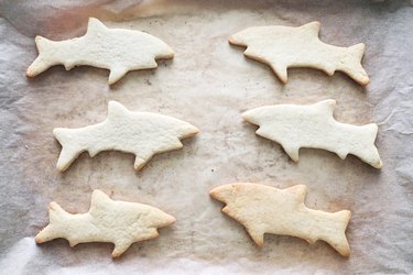 Baked shark cookies on a sheet pan
