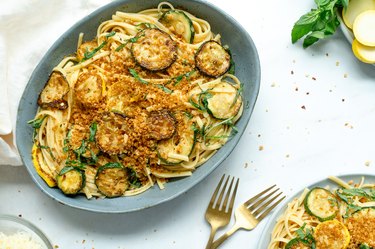 zucchini summer pasta served with forks.