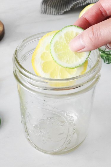 Add lemon and lime slices to a jar