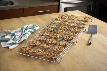 Nifty Solutions' expandable cooling rack, shown filled with cookies on a butcher block countertop
