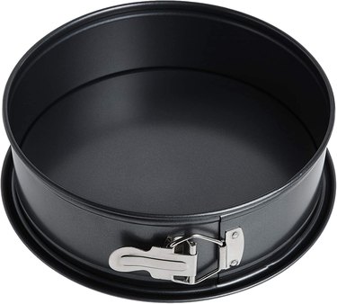 Nordic Ware springform pan shown against a white ground, latch prominently featured at the front.