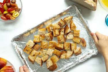 toasted bread cubes on a baking sheet.