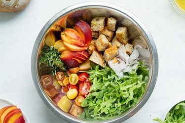 panzanella ingredients in a bowl ready to toss.