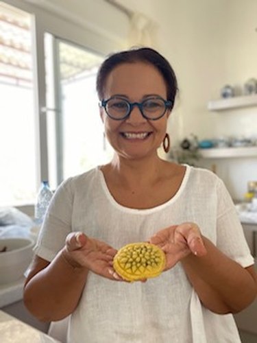 Chef Fariba holds up a kolompeh pastry