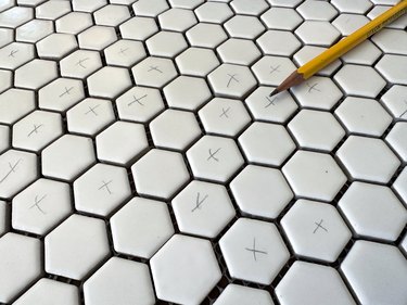 White tiles topped with small "x" marks in pencil