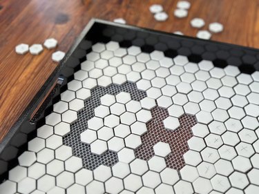 Letters "CH" removed from white tile tray