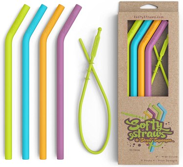 4 silicone straws (green, blue, orange, purple) and a cleaning tool in biodegradable packaging.