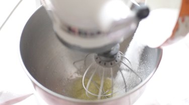 Pouring sugar into a bowl with egg whites