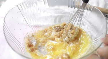 Mixing butter and sugars in a large bowl.