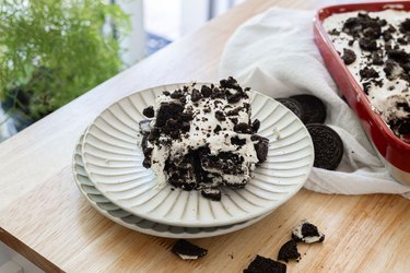 Slice of Oreo icebox cake on a fluted plate.