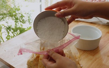 Adding powdered sugar to bag.