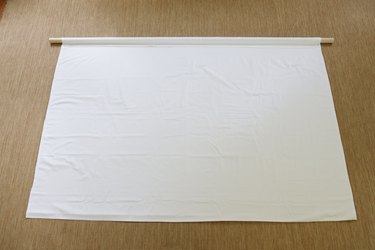 Sheet folded over long wood dowel