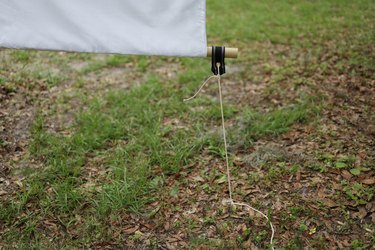 Movie screen tethered to the ground with rope and ground stake