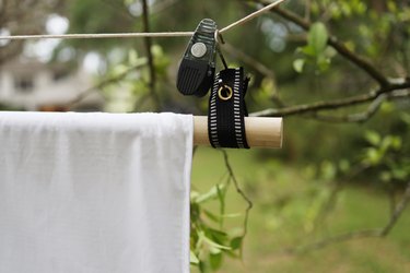 Movie screen hanging outside with S-hook and rope