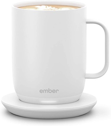 White Ember warming mug with a square-ish handle on a matching round warming pad.