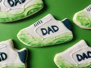 Finished grass-stained Father's Day cookies on green background