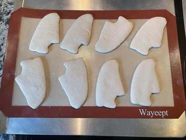 plain, baked, sneaker-shaped cookies on baking sheet