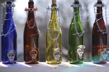Lineup of wine bottle bird feeders