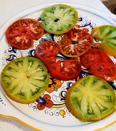 A sliced Cherokee Green tomato has green flesh.