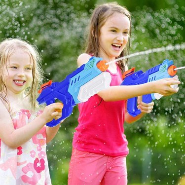Two young girls playing with Quanquer Water Blasters.