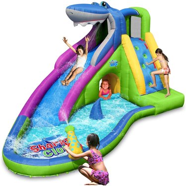 Kids playing on Action Air Inflatable Waterslide against white background.