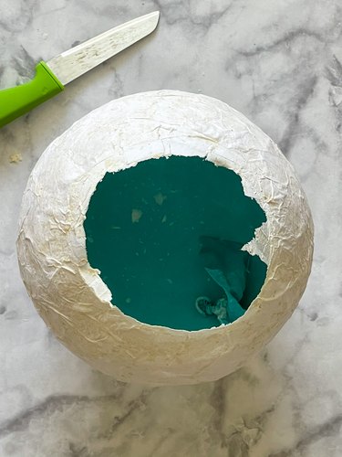 The dry papier-mâché with the blue balloon popped