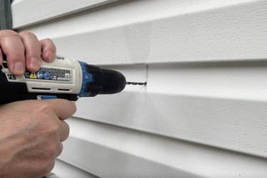 Drilling a hole into exterior siding