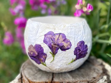 A finished pressed-flower paper lantern with purple blooms