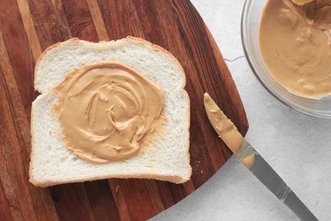 Spread nut butter on bread