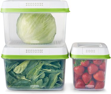 Three medium and large food storage containers with cabbage, spinach and strawberries