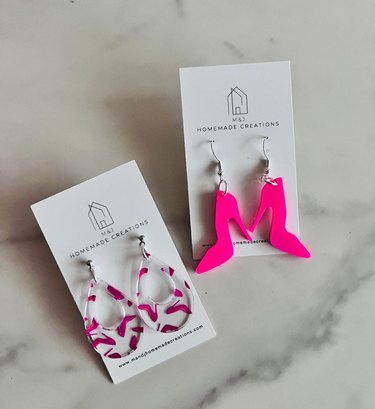 Two pairs of earrings, one of hot pink high heel cutouts