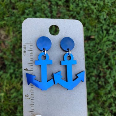 Pair of blue earrings shaped like anchors