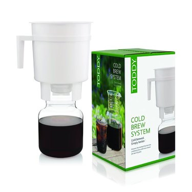 Toddy Cold Brew Coffee System against a white background. The coffee maker is pictured next to the box it comes in.