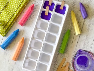 chalk mixture in ice cube tray with mini craft sticks inserted