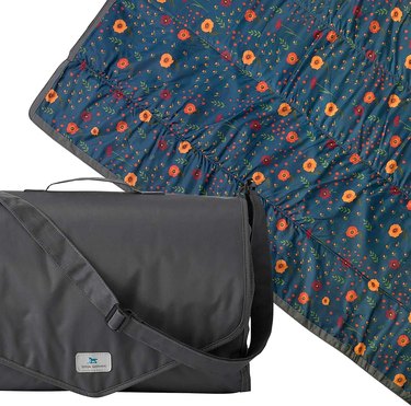 Little Unicorn Outdoor Blanket in pattern 'Midnight Poppy' with black carrying case.
