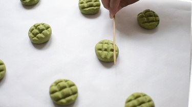 Creating indents in matcha dough for turtle shells.
