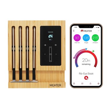 MEATER Block (presumably named after its wooden stand) with four dual sensor temperature probes and an example of what the app looks like on a smartphone.