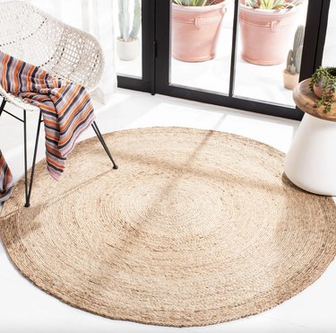 Round jute rug sitting underneath a chair and table