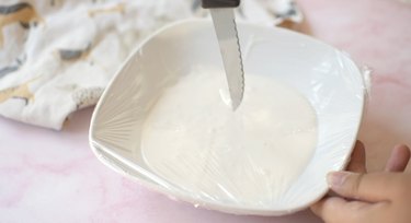 Poking holes in plastic wrap with a knife